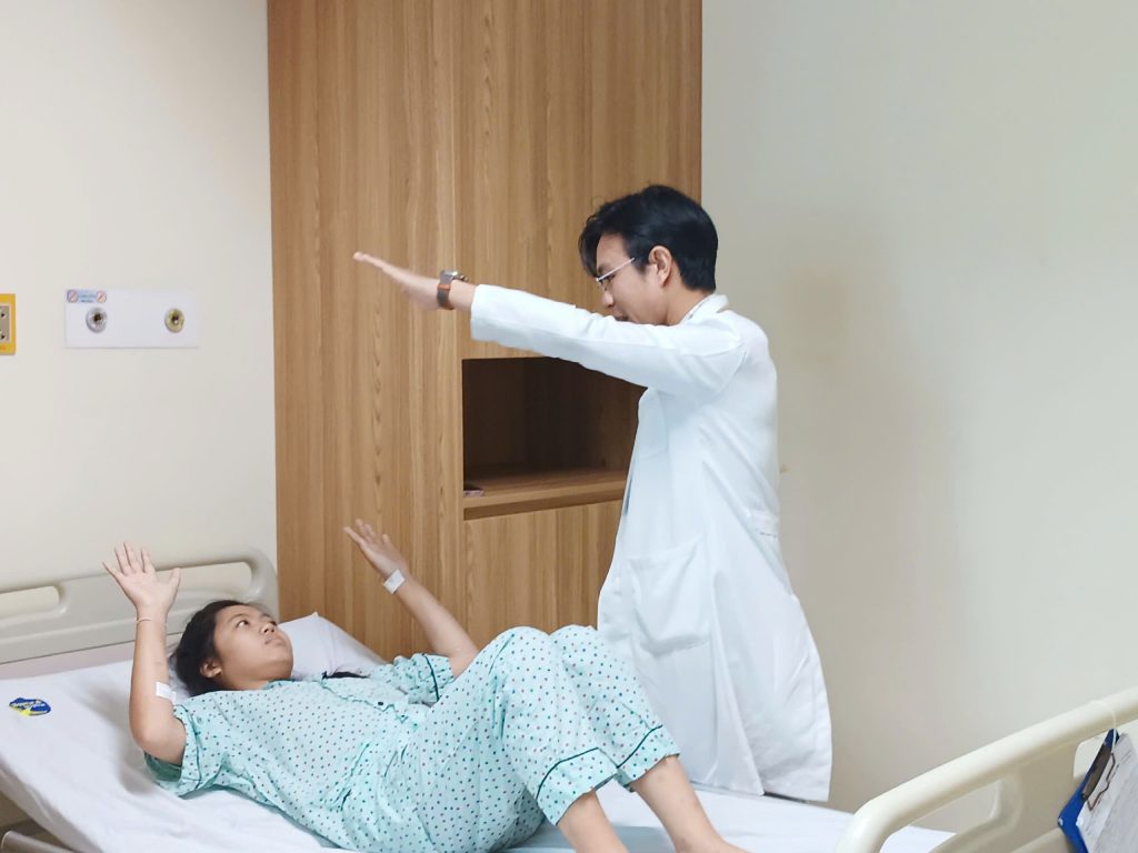 Hình ảnh bác sĩ kiểm tra chức năng vận động sau mổ u sọ hầu