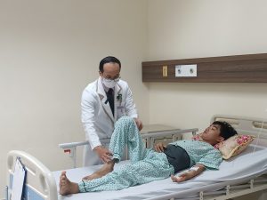 Hình ảnh bác sĩ hướng dẫn bệnh nhân cử động sau phẫu thuật